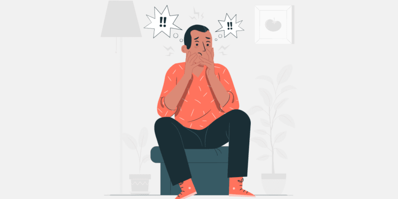 Ilustração de uma homem sentado, com semblante preocupado, demonstrando desequilíbrio emocional. Acima da cabeça dele há dois balões com dois pontos de exclamação em cada um.